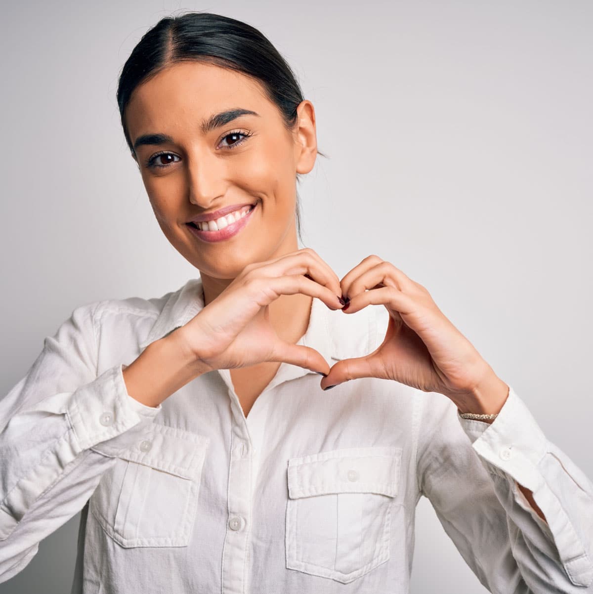 woman making heart shape with hands
